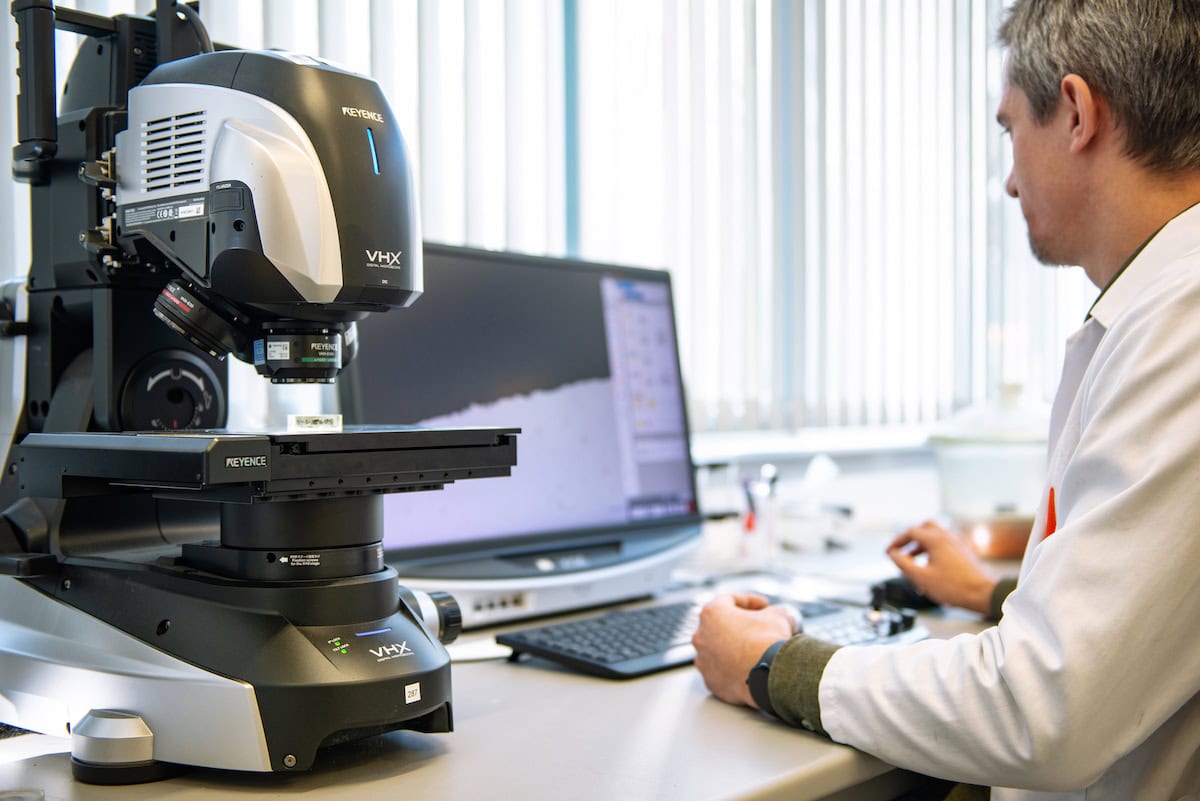 Staff working at a digital microscope in the IFO laboratory