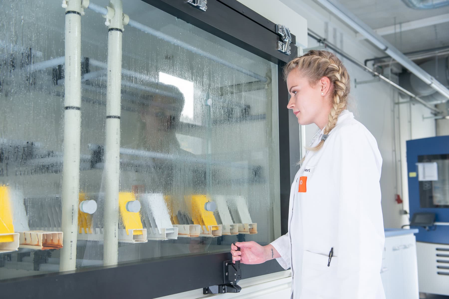 Laboratory technician at the condensation climate test chamber