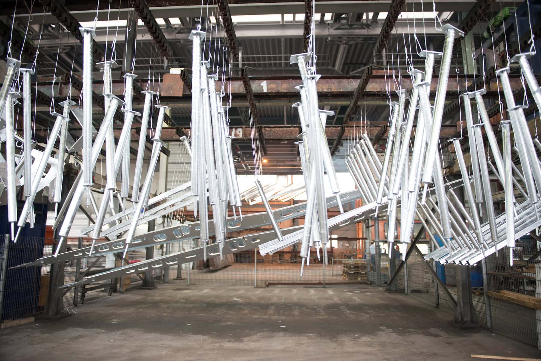 Galvanised steel parts on a rack in a hot-dip galvanising plant
