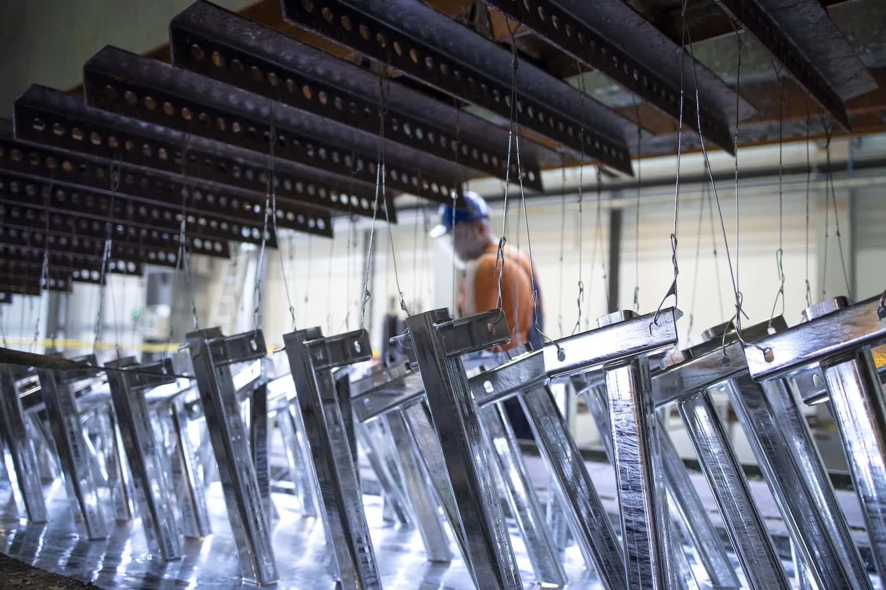 Steel components on a rack in a galvanising plant